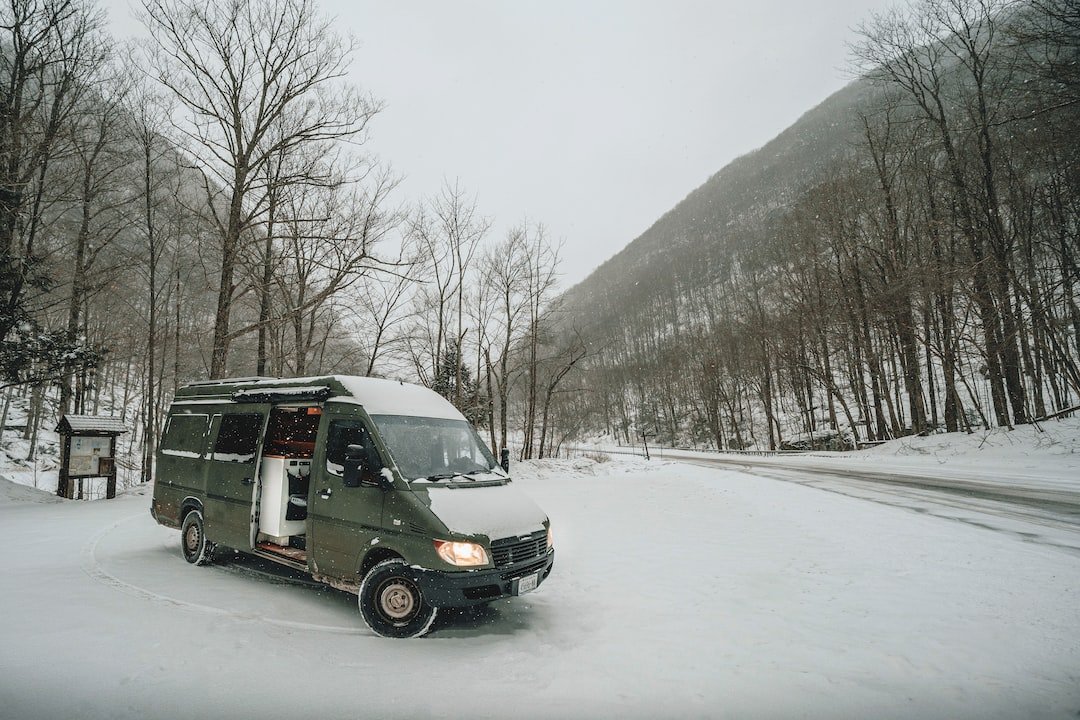 a van is parked on a snowy road