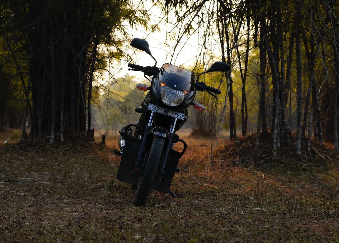 a motorcycle parked in the middle of a forest