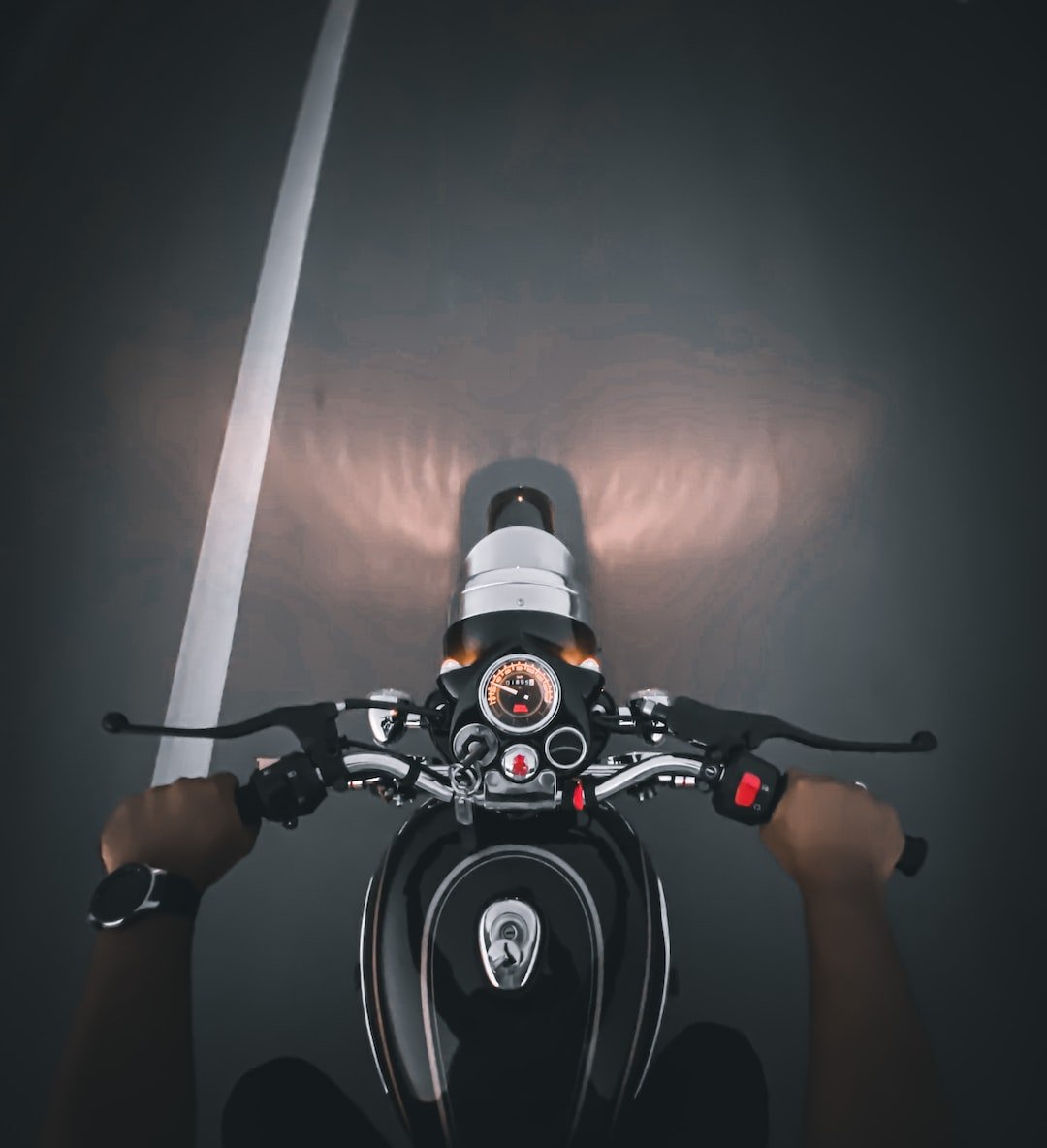 a person riding a motorcycle on a dark street