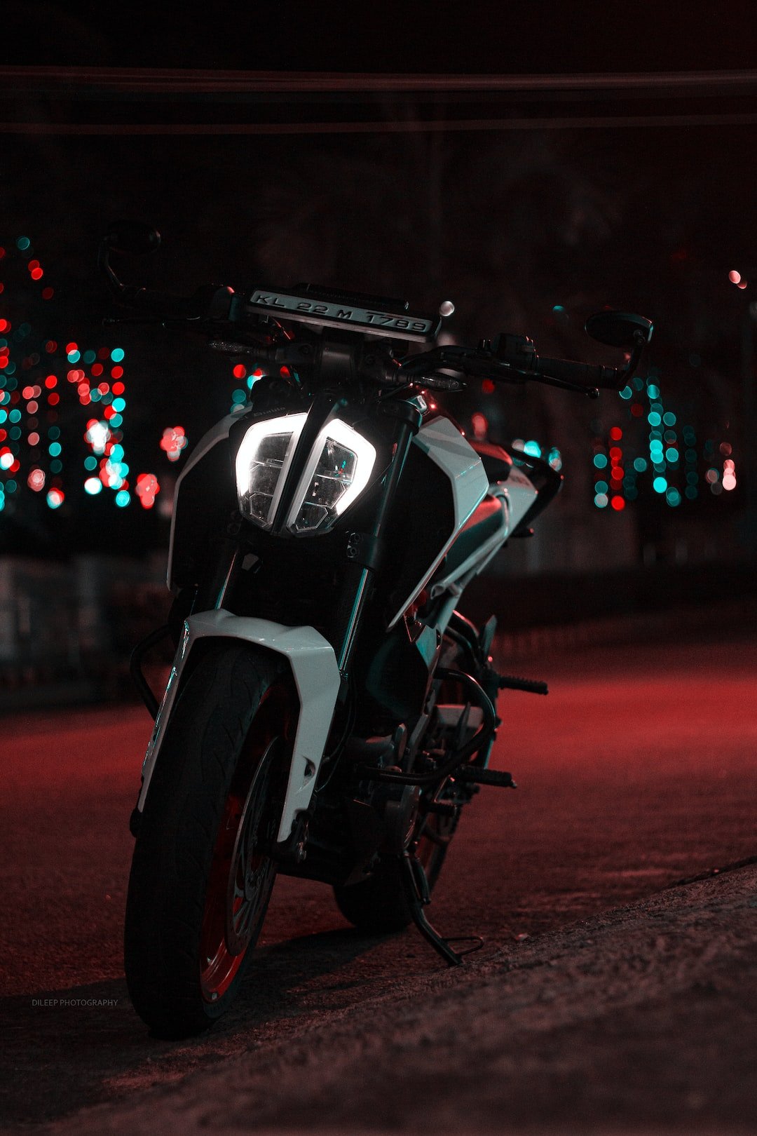 black and white motorcycle on road during night time