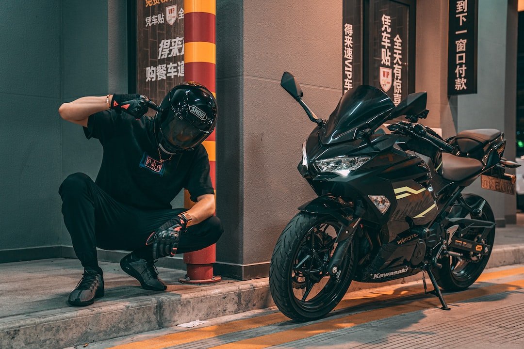 man in black jacket and black helmet riding black sports bike