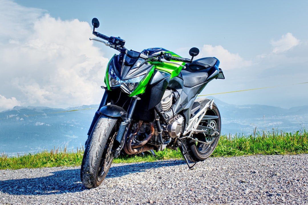 black and green sports bike on gray dirt road during daytime
