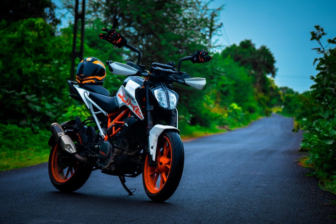 black and orange motorcycle on road during daytime