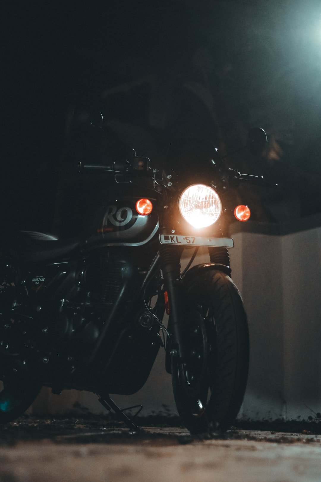 a motorcycle parked in a dark room with a light on