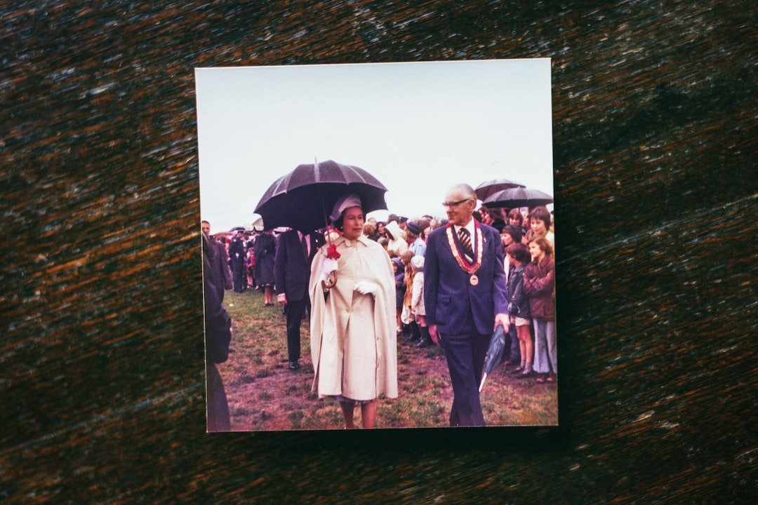 a man and woman walking down a path with an umbrella