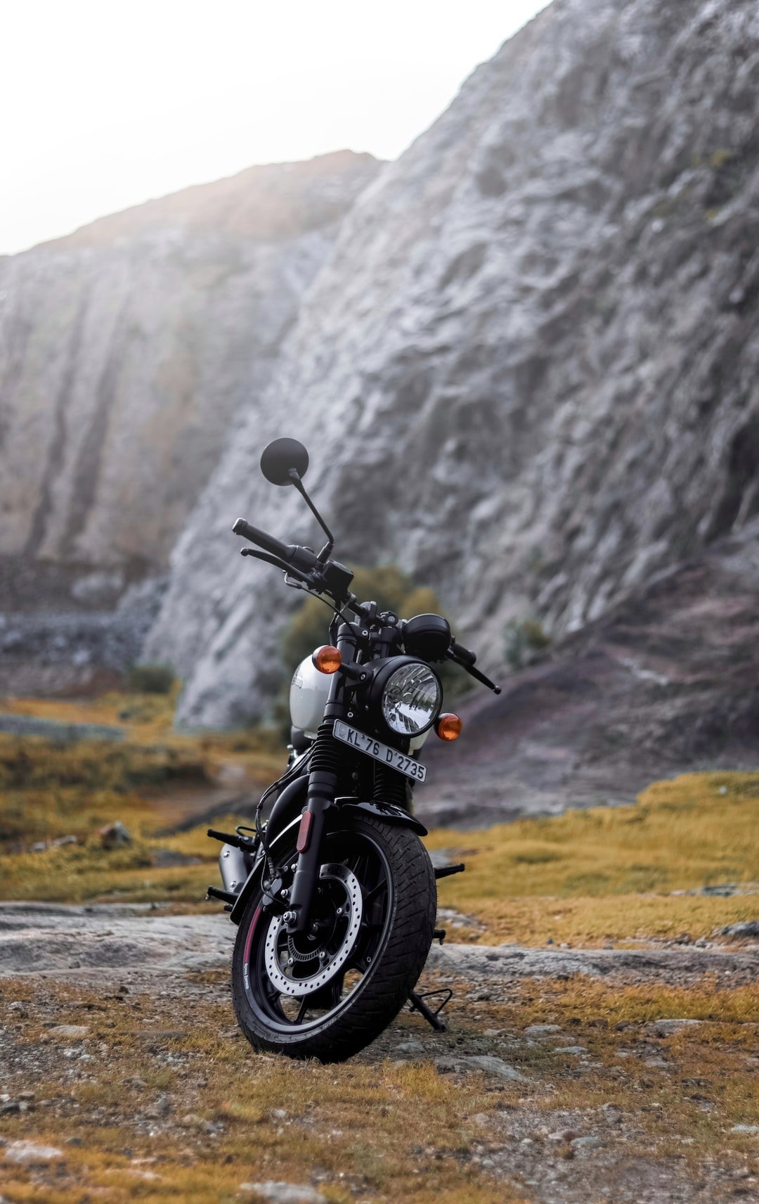 a motorcycle parked in front of a mountain